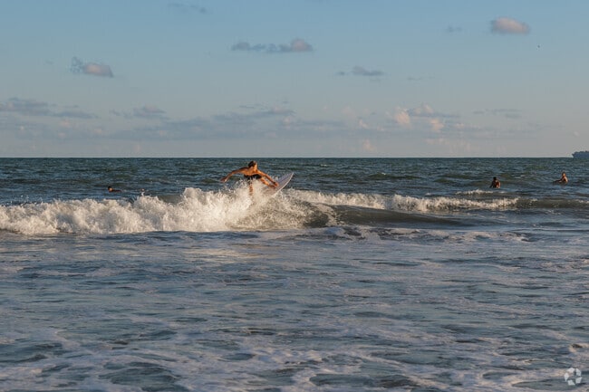Locals enjoy surfing the waves on the waves on the north side of the pier on Isle of Palms.