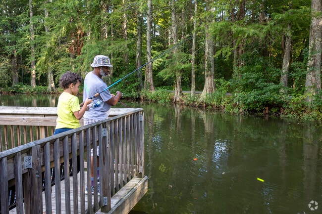 Some people fish while others catch fish in Keeley Park's pond.