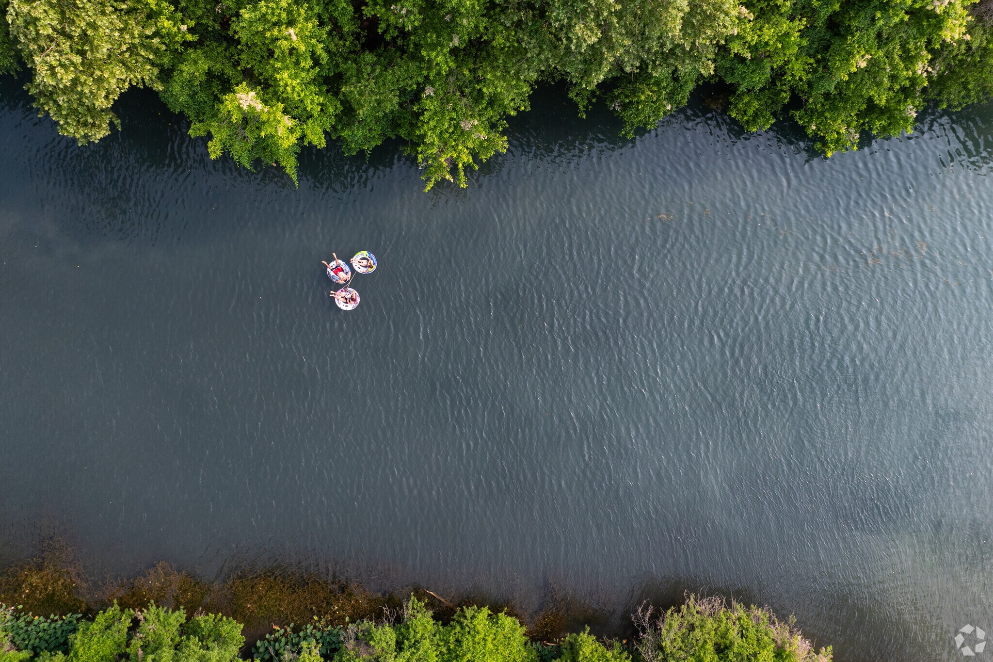 Friends enjoying a calming float down the Comal River at Hinman Island Park.