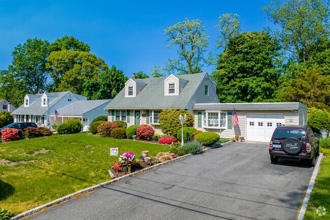 This street in East Northport is lined with well-kept Cape Cod homes.