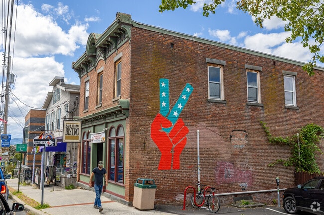 A peace‑sign mural reflects New Paltz’s creative, college‑town vibe.