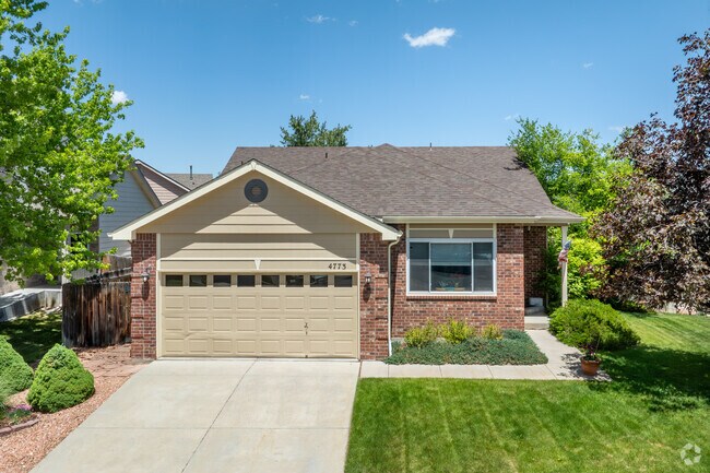 This ranch-style brick home in Country Hills is surrounded by mature trees and boasts a spacious, inviting yard, offering both curb appeal and a peaceful, private outdoor space.