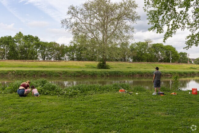 Visitors of Island Metropark enjoy fishing in the river as a family.