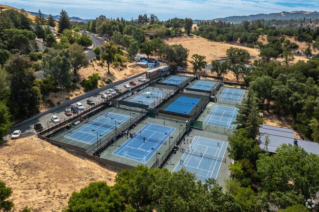 People hitting aces and enjoying the game at the Lafayette Tennis Club's stunning courts.