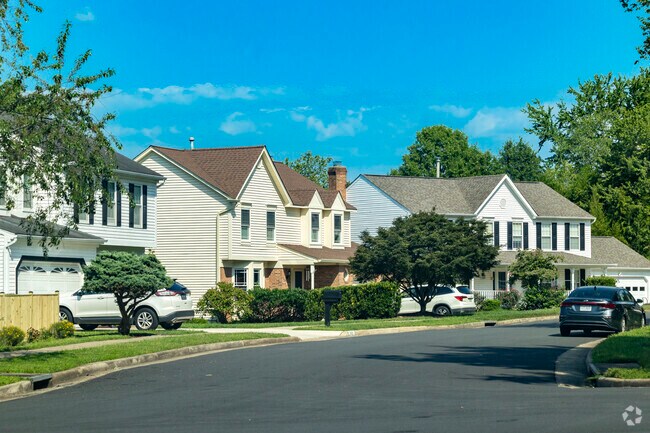 Single family homes line Bull Run East streets, many with garages and manicured lawns.