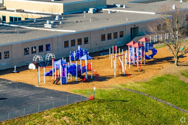 Colorful playgrounds are located next to a basketball court at Fort Allen Elementary School.