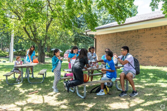 Kids gather for a treat during summer camp at Douglas Park near King Park.