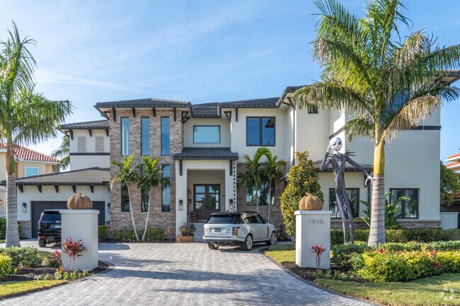 A modern spanish mansion stands glistening in the sun on Venetian Isles.