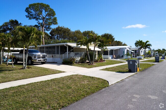 Palm trees and screened in patios can be seen throughout the Tropical Breeze neighborhood.