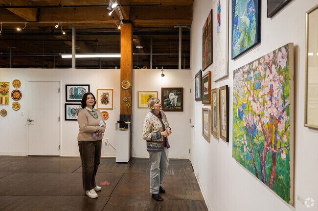 A visitor admires art at the Loading Dock Art Gallery in Lowell, MA.