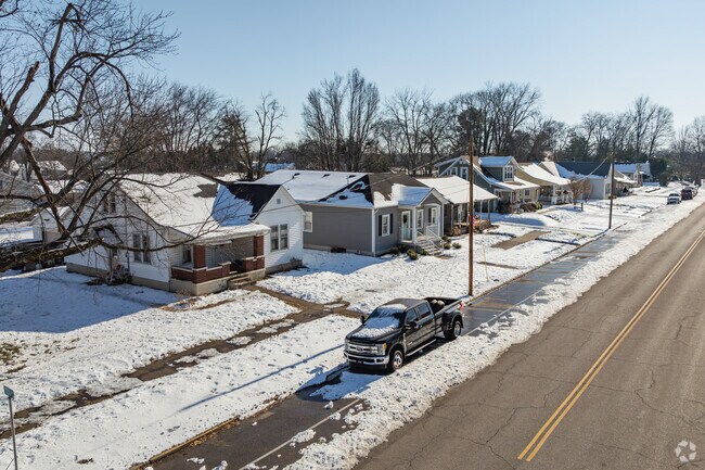 Homes are often fronted by mid-sized lawns with paved driveways and detached garages.