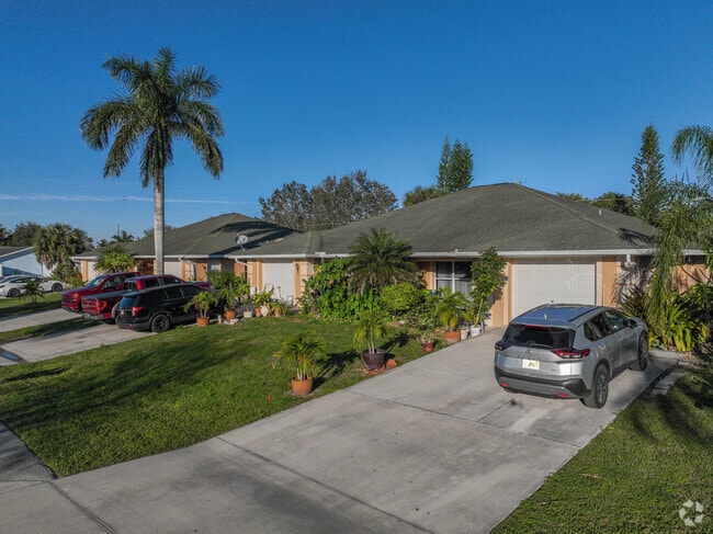 Pastel stucco homes juxtapose bright blue skies and green lawns in Golden Gate.