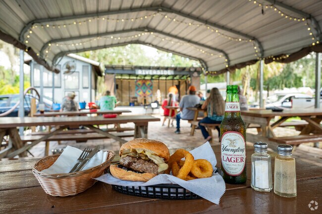 Enjoy the NobleTON burger and a beer with friends with live music at the Riverside Restaurant.