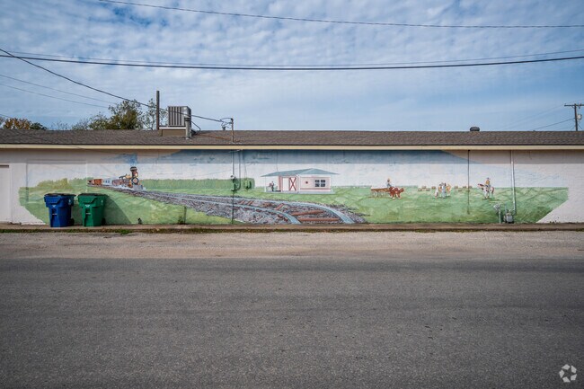 A country themed mural sits alongside a building in downtown Sweeny, Texas.