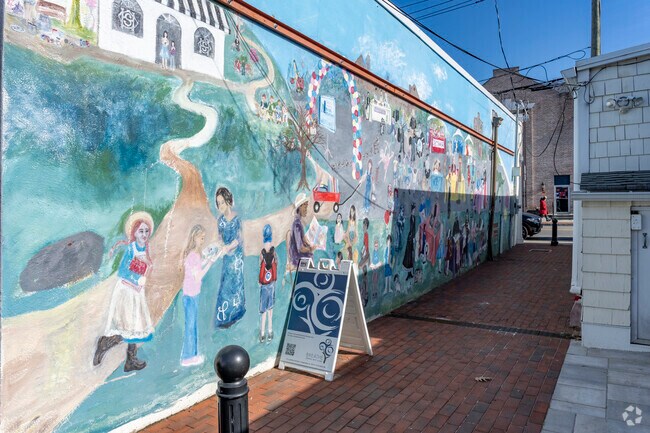 Bright artwork adorns the walls of a walkway in downtown Chappaqua.