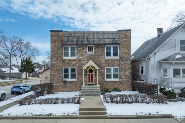 There are many detached single family homes in Sturtevant like this brick four square.