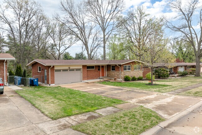 Overland has streets with brick ranch homse and mature trees.