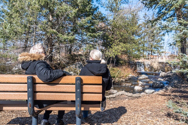 Two woman enjoy sitting by the waterfall at Lake Katherine.