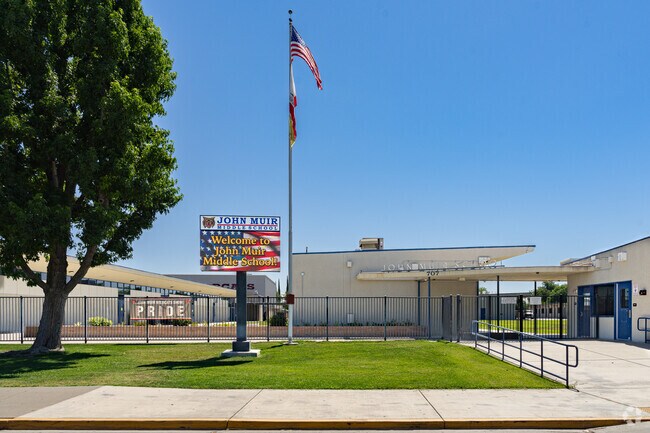 A lighted marquee at the entrance to John Muir Middle School informs parents of upcoming events.