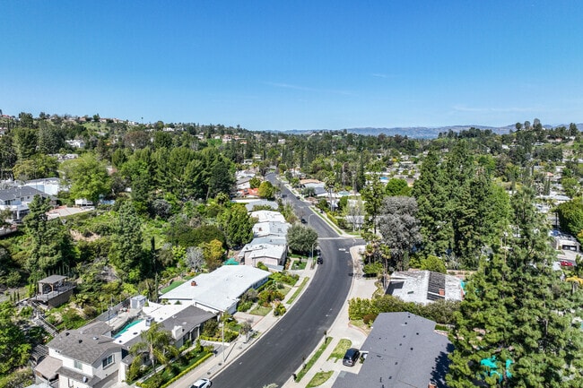 Lush greenery lines the street in this residential area in Southern Tarzana.