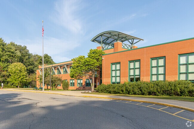 A flag pole stands tall over Florence Sawyer School.