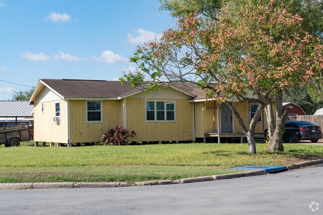 A yellow wood frame style home located in the north side of La Villa.