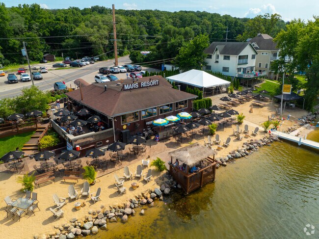 Guests gather at Mars Resort’s lakeside patio and beach on a sunny Wisconsin afternoon.