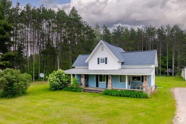 Homes in South Boardman are surrounded by tall trees.