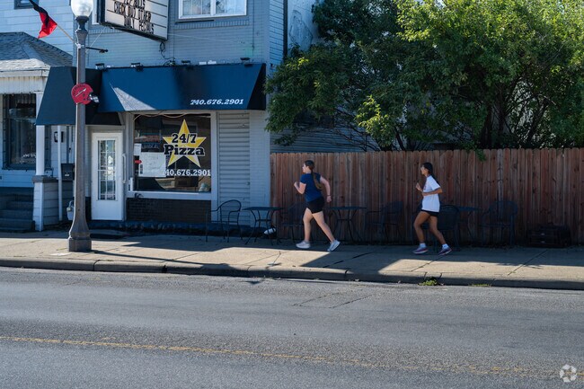Joggers head out for a run past 24/7 Pizza in Bellaire.