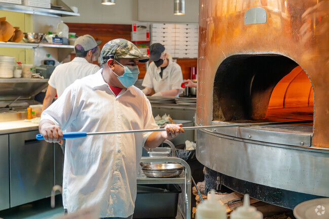 Pizzeria Lola makes its hot fresh pizza in front of their customers.