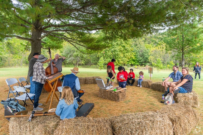 Families gather around the music at Harvest of the Acorn Moon Fall Festival in South Farmsworth.