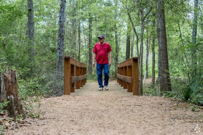 A resident of Hillcrest enjoys a peaceful stroll along a wooded trail at Camp Mohawk.