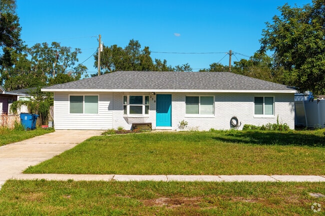 This ranch-style home in Davenport features fresh exterior paint and a colorful front door.