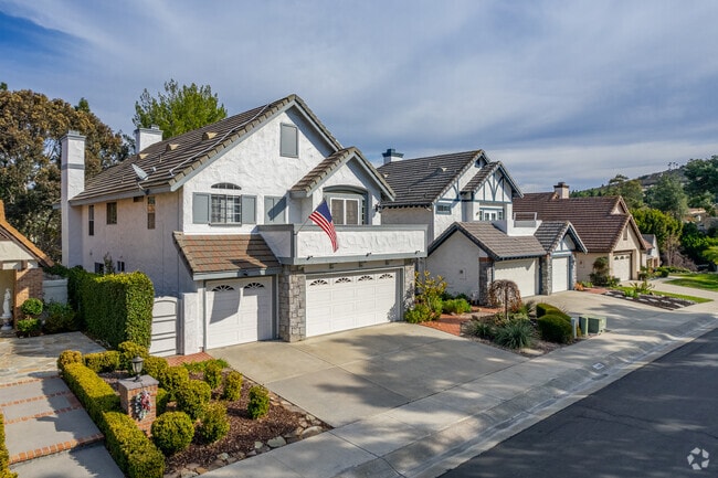 Two-story, stucco, Spanish-inspired homes in the neighborhood have small or no lawns.