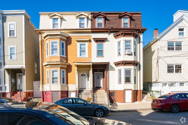 Some homes in Central Maverick Square share the same building but are different colors.