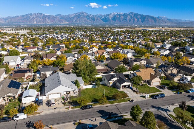 An aerial view of Oquirrh Shadows shows a well planned neighborhood with a view of the mountains