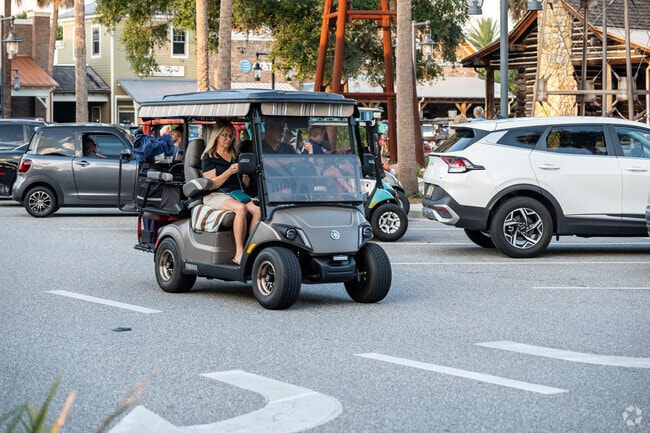 Residents of the Village of Buttonwood use golf carts to access area amenities.