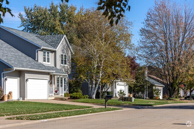 A typical established neighborhood in Bettendorf has mature trees and varying styles of homes.