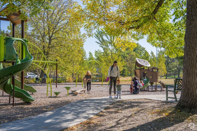 Parents play with their children at the Arden Park playground.