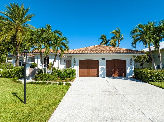 Punta Rassa homes come with covered garages, beautiful front yards and large driveways.