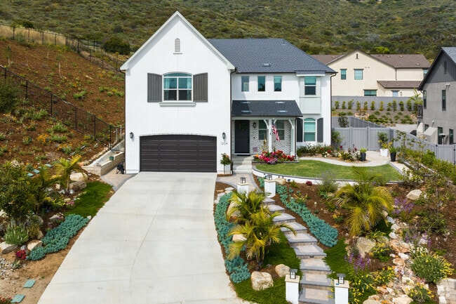 Expansive driveways lead to farmhouse-style homes in San Marcos.