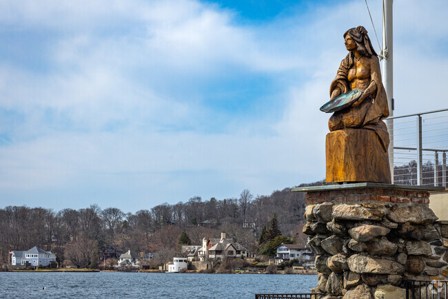 A majestic sculpted wooden statue of Princess White Deer gazes over Lake Mohawk from the boardwalk as a memorial to longtime general manager of the country club and local hero, Frances Smith.
