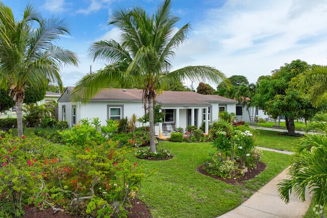 A beautifully kept garden surrounds a ranch-style home in Whispering Palms.