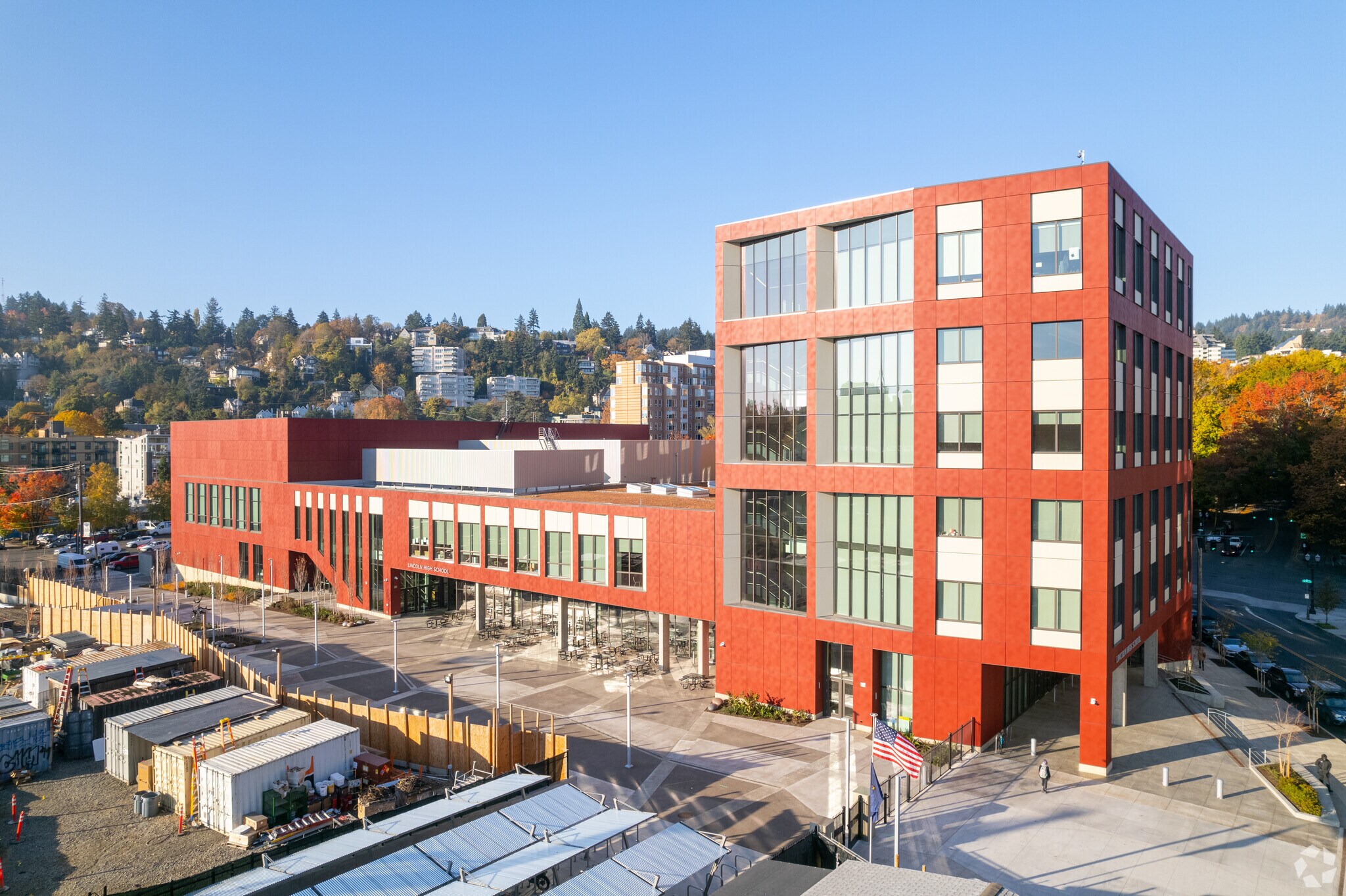 Lincoln High School view of front with the red design and multiple stories in Uptown, Portland.