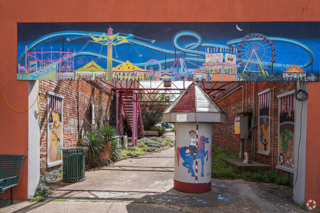 Yazoo City’s Peyton Carlton adds circus flair to a downtown building walkway.