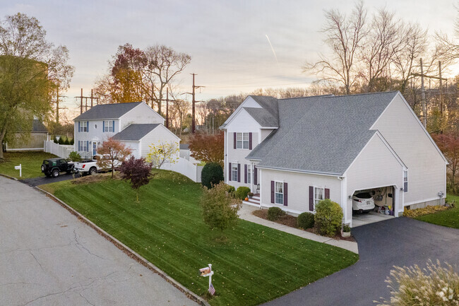 Rows of neat home sit quietly on Natick streets as the sun sets.