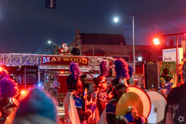 Santa rides atop a firetruck to begin the tree lighting ceremony near Seminary District.
