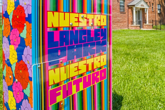 A traffic signal box doubles as a brightly colored herald of community pride as part of a CASA-sponsored art project in Langley Park.