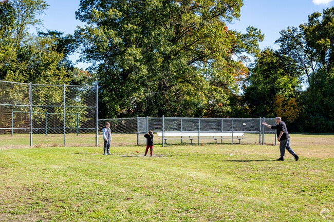 Residents are practicing their swings at Norwood Field.