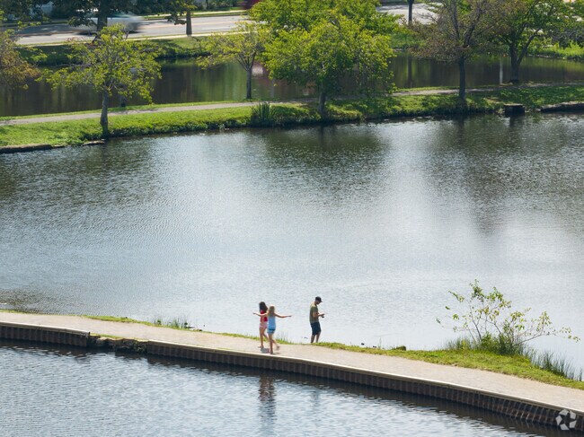 Babylon residents fishing and walking in the park.